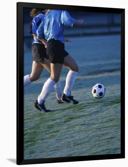 Two Teenage Girls Running for a Soccer Ball-null-Framed Photographic Print