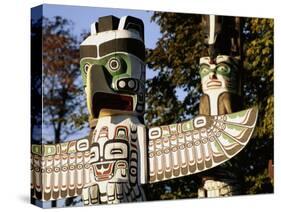 Two Totem Poles, Stanley Park, Vancouver, British Columbia, Canada-Walter Bibikow-Stretched Canvas