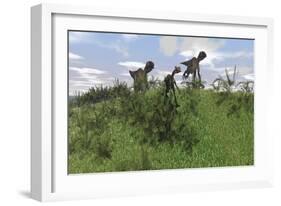 Two Utahraptors Chasing a Gigantoraptor across a Grassy Field-null-Framed Art Print