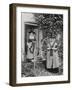 Two Welshwomen in Traditional Dress Stand Outside Their Cottage with a Spinning Wheel-null-Framed Photographic Print