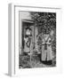 Two Welshwomen in Traditional Dress Stand Outside Their Cottage with a Spinning Wheel-null-Framed Photographic Print