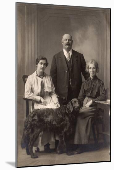 Two Women and a Man with a Flat-Coated Retriever-null-Mounted Photographic Print