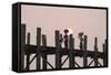 Two Women Carrying Bags on their Heads and Small Girl Crossing U Bein Teak Bridge-Stephen Studd-Framed Stretched Canvas