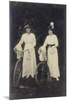 Two Women with Bicycles, Carrying Purses-null-Mounted Premium Photographic Print