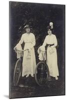 Two Women with Bicycles, Carrying Purses-null-Mounted Photographic Print