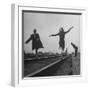 Two Young Ballet Russe Dancers Balancing on the Railroad Tracks in the Station While on Tour-Myron Davis-Framed Photographic Print