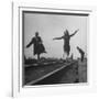 Two Young Ballet Russe Dancers Balancing on the Railroad Tracks in the Station While on Tour-Myron Davis-Framed Photographic Print