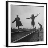 Two Young Ballet Russe Dancers Balancing on the Railroad Tracks in the Station While on Tour-Myron Davis-Framed Photographic Print