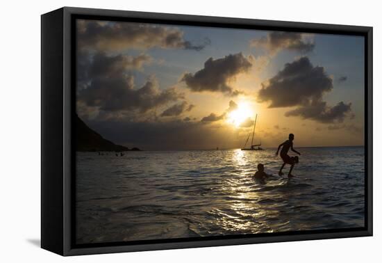 Two Young Boys Attempt to Surf on Praia Da Conceicao Beach at Sunset-Alex Saberi-Framed Stretched Canvas