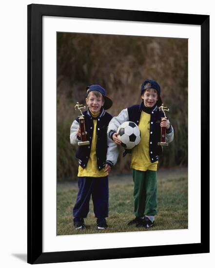 Two Young Brothers Posing with their Soccer Trophies-Paul Sutton-Framed Photographic Print