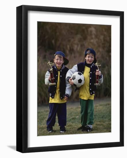 Two Young Brothers Posing with their Soccer Trophies-Paul Sutton-Framed Photographic Print