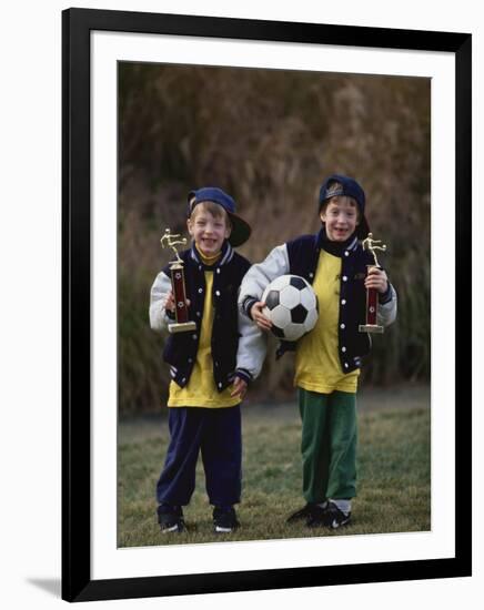 Two Young Brothers Posing with their Soccer Trophies-Paul Sutton-Framed Photographic Print
