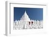 Two young Buddhist monks stand on the white walls of Hsinbyume Pagoda holding red umbrellas, Mingun-Tim Mannakee-Framed Photographic Print