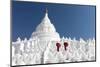 Two young Buddhist monks stand on the white walls of Hsinbyume Pagoda holding red umbrellas, Mingun-Tim Mannakee-Mounted Photographic Print