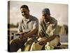 Two Young Men Sitting on The Pier Fishing-null-Stretched Canvas