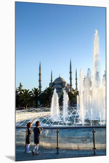 Two Young Turkish Girls Pointing to the Blue Mosque, UNESCO World Heritage Site-James Strachan-Mounted Premium Photographic Print