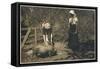 Two Young Women Tend to Pigs in Their Pen-null-Framed Stretched Canvas