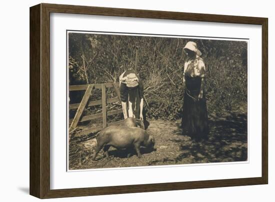 Two Young Women Tend to Pigs in Their Pen-null-Framed Art Print