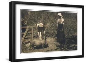 Two Young Women Tend to Pigs in Their Pen-null-Framed Art Print