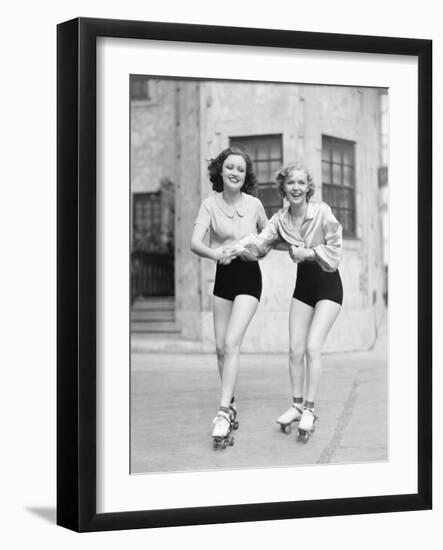 Two Young Women with Roller Blades Skating on the Road and Smiling-null-Framed Photo