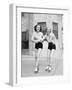 Two Young Women with Roller Blades Skating on the Road and Smiling-null-Framed Photo