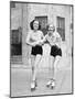 Two Young Women with Roller Blades Skating on the Road and Smiling-null-Mounted Photo