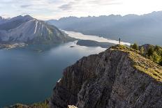 Freestyle skier doing a trick off a jump above city at sunset, Canada, North America-Tyler Lillico-Stretched Canvas