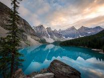 Freestyle skier doing a trick off a jump above city at sunset, Canada, North America-Tyler Lillico-Stretched Canvas