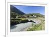 Typical red Swiss train on Hospental Viadukt surrounded by creek and green meadows, Andermatt, Cant-Roberto Moiola-Framed Photographic Print