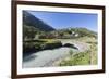 Typical red Swiss train on Hospental Viadukt surrounded by creek and green meadows, Andermatt, Cant-Roberto Moiola-Framed Photographic Print