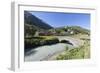 Typical red Swiss train on Hospental Viadukt surrounded by creek and green meadows, Andermatt, Cant-Roberto Moiola-Framed Photographic Print