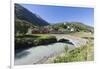 Typical red Swiss train on Hospental Viadukt surrounded by creek and green meadows, Andermatt, Cant-Roberto Moiola-Framed Photographic Print