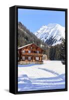 Typical wooden hut framed by woods and snowy peaks, Langwies, district of Plessur, Canton of Graubu-Roberto Moiola-Framed Stretched Canvas