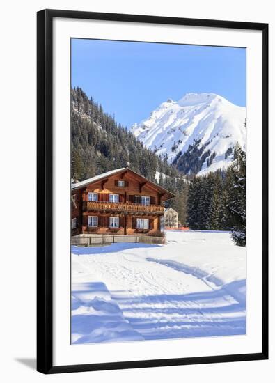 Typical wooden hut framed by woods and snowy peaks, Langwies, district of Plessur, Canton of Graubu-Roberto Moiola-Framed Photographic Print