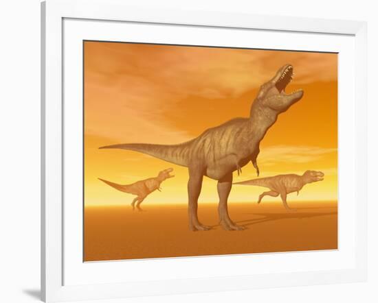 Tyrannosaurus Rex Dinosaurs in an Orange Foggy Desert by Sunset-null-Framed Art Print