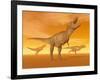 Tyrannosaurus Rex Dinosaurs in an Orange Foggy Desert by Sunset-null-Framed Art Print