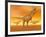 Tyrannosaurus Rex Dinosaurs in an Orange Foggy Desert by Sunset-null-Framed Art Print