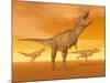 Tyrannosaurus Rex Dinosaurs in an Orange Foggy Desert by Sunset-null-Mounted Art Print