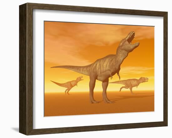 Tyrannosaurus Rex Dinosaurs in an Orange Foggy Desert by Sunset-null-Framed Art Print