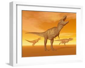 Tyrannosaurus Rex Dinosaurs in an Orange Foggy Desert by Sunset-null-Framed Art Print