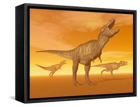 Tyrannosaurus Rex Dinosaurs in an Orange Foggy Desert by Sunset-null-Framed Stretched Canvas