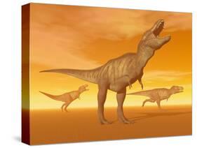 Tyrannosaurus Rex Dinosaurs in an Orange Foggy Desert by Sunset-null-Stretched Canvas