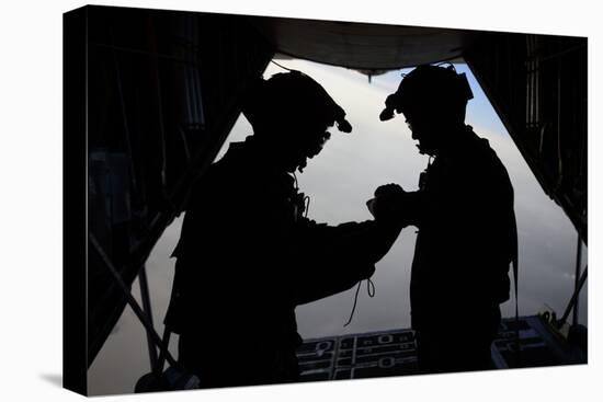 U.S. Air Force Loadmasters Fold the American Flag Aboard an Hc-130 Hercules-null-Stretched Canvas