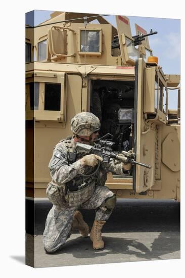 U.S. Army Soldier Shouts to a Fellow Soldier Inside a Humvee-null-Stretched Canvas