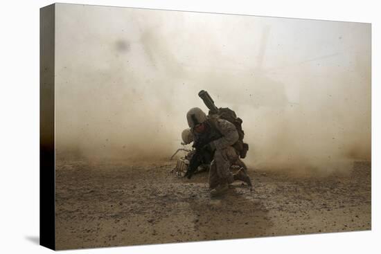 U.S. Marine Shields Himself from Dust Being Kicked Up from a Ch-53E Super Stallion-null-Stretched Canvas