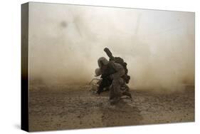 U.S. Marine Shields Himself from Dust Being Kicked Up from a Ch-53E Super Stallion-null-Stretched Canvas