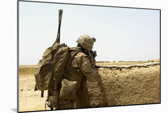 U.S. Marine Takes Cover Behind a Wall During a Patrol in Afghanistan-null-Mounted Photographic Print
