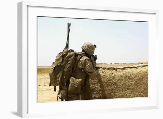 U.S. Marine Takes Cover Behind a Wall During a Patrol in Afghanistan-null-Framed Photographic Print