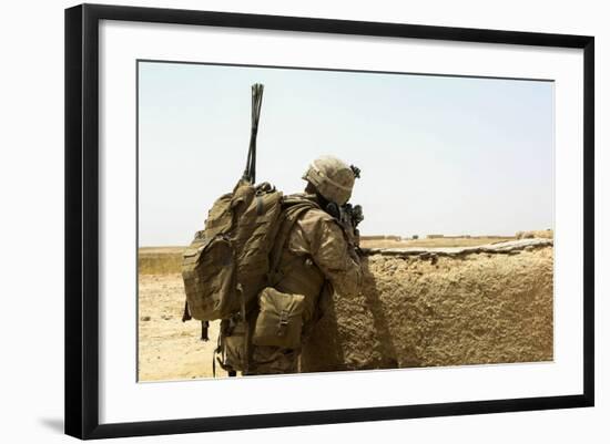 U.S. Marine Takes Cover Behind a Wall During a Patrol in Afghanistan-null-Framed Photographic Print