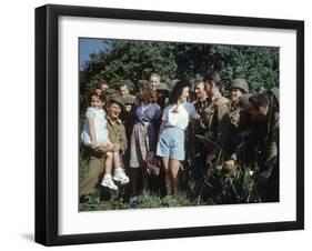 U.S. Soldiers Gather around a French Girl Near Avranches, France, August 1944-Frank Scherschel-Framed Photographic Print